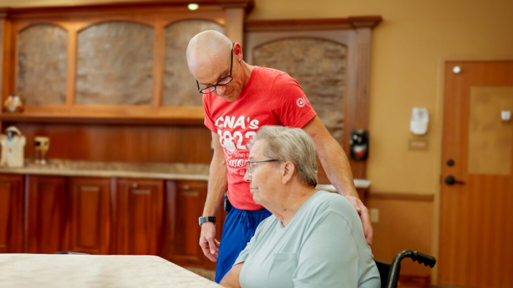A nurse smiles at a respite care patient